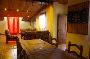 a dining room with a wooden table and chairs at Villa de Xicar in Montejicar
