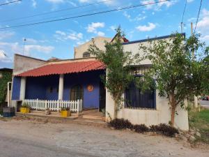 a blue and white house on the side of the street at La casa azul en Ticul Yucatán in Ticul