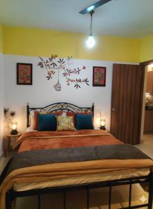 ein Schlafzimmer mit einem großen Bett und blauen Kissen in der Unterkunft MalangFehmi Goa Escape in Arambol + 4 Fotos