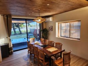 ein Esszimmer mit einem Holztisch und Stühlen in der Unterkunft Koji Bliss - Vacation STAY 93231v in Shirako + 16 Fotos