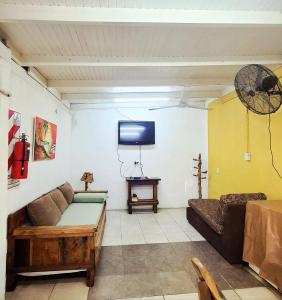 un soggiorno con divano e TV a schermo piatto di Dona Monica a Ituzaingó