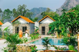 a villa with a pool in front of a resort at The Sam Home in Nguyên Ngoại