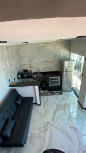 a living room with a couch and a refrigerator at Duplex beira mar ilha grande proveta in Angra dos Reis