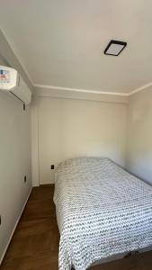 a bedroom with a bed in a white room at Duplex beira mar ilha grande proveta in Angra dos Reis