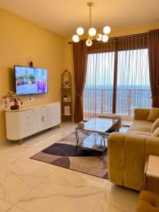 a living room with a couch and a flat screen tv at Skyhouse bsd tower duxton 2 in Samporo