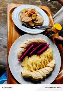 two plates of food on a wooden table at D'Bulan bungalows and kafe in Tetebatu +34 photos