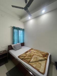 a bedroom with a bed with a ceiling fan at HOTEL ROYAL CiTY KOCH BEHAR in Koch Bihār