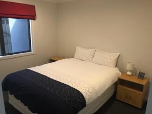 a bedroom with a bed and a window at Parklands paradise 3bedroom4beds in Napier