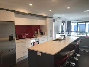 a kitchen with a counter and a sink and appliances at Parklands paradise 3bedroom4beds in Napier