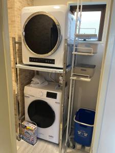 een magnetron en een wasmachine en droger in de kamer bij Shinehouse2 in Kawaguchi