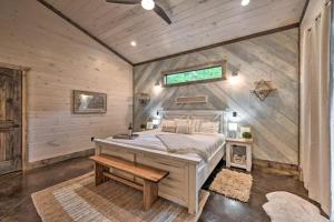 a bedroom with a bed in a room with wooden walls at Moonlight Trail in Broken Bow