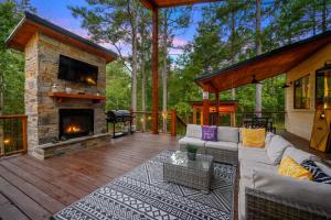 a patio with a couch and a fireplace at Moonlight Trail in Broken Bow