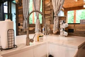 a kitchen counter with a sink in a cabin at Moonlight Trail in Broken Bow +64 photos