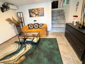 a living room with a couch and a table at Seaview Love Nest in Ko Phangan