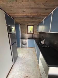 a kitchen with a refrigerator and a washer and dryer at Bosch Rest in Pretoria