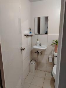 ein weißes Badezimmer mit Waschbecken und Toilette in der Unterkunft Casita Bonita in Marilao