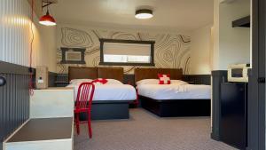 Postel nebo postele na pokoji v ubytování Hotel Expedition