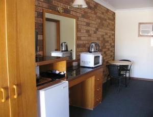 a kitchen with a counter top with a microwave at Lucky Strike Motel in Tomingley