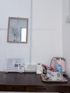 a counter top with a coffee maker and a mirror at Mercy Mountain Home in Kundasang +61 photos