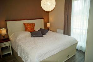 a bedroom with a bed with two pillows on it at Premium Apartments in Wendisch Rietz
