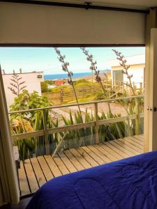 een slaapkamer met uitzicht op de oceaan vanaf een balkon bij Cabañas la boca 3 in La Boca +5 foto's