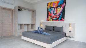 a bedroom with a bed with a painting on the wall at Villa Nice in Lamai +35 photos