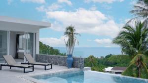 a villa with a swimming pool and palm trees at Villa Nice in Lamai