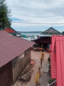 an overhead view of a building with pink roofs at The Two Tigers - Sok San Village in Phumĭ Kaôh Rŏng +32 photos