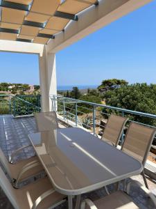 a table and chairs on a balcony with a view at Eureka Kythira 