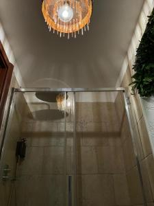 a bathroom with a shower and a chandelier at Ca' Teatro Vecchio in Manfredonia +28 photos