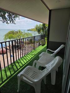 balcone con 2 sedie bianche e vista sull'oceano di Mong DOO SEA HOME 