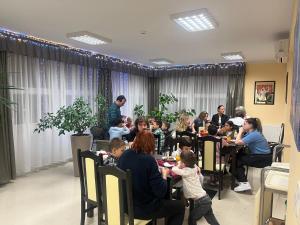a group of people sitting at tables eating food at Arkánum Hotel in Balatonmáriafürdő