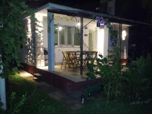 a porch of a house with a table and chairs at Vintage Summer House in Budva +19 photos