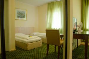 Postel nebo postele na pokoji v ubytování Panorama Hotel Frankfurt Offenbach Süd