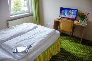 מיטה או מיטות בחדר ב-Panorama Hotel Frankfurt Offenbach Süd