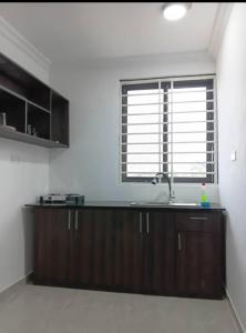 a kitchen with a sink and a window at Meg place in Amamoli
