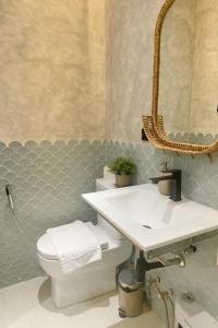 Un baño con lavabo, inodoro y espejo. en Caliraya Mountain Lake Resort, en Cavinti 50 fotos más