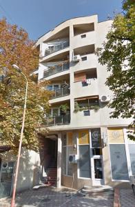 an apartment building with a staircase in front of it at La Hitana in Lazarevac