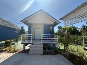 a small blue and white house with a porch at ต้นตาล&ตาลฟ้า รีสอร์ท in Ban Nong Khang +4 photos
