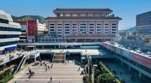 a large building with people walking in front of it at Century Plaza Hotel in Shenzhen