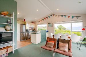 a kitchen and living room with a table and chairs at Sea View Batch in Tata Beach