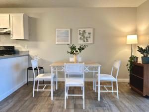 a kitchen and dining room with a table and chairs at Cozy One-Bedroom Haven with Big Balcony in Vancouver +3 photos