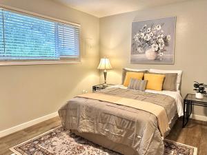 a bedroom with a bed and a window at Cozy One-Bedroom Haven with Big Balcony in Vancouver