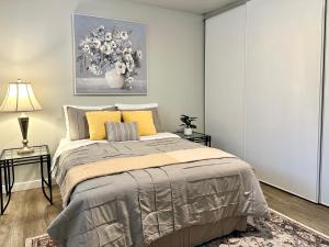 a bedroom with a bed and a vase of flowers at Cozy One-Bedroom Haven with Big Balcony in Vancouver