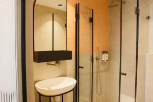 a bathroom with a shower and a toilet and a sink at Jrose Hotel in Jerusalem