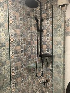 een douche met een douchekop in een badkamer bij Centrio Tower New Condo unit 2 in Cagayan de Oro