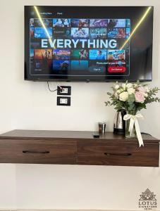 a flat screen tv hanging on a wall at Lotus signature hotel in Cairo