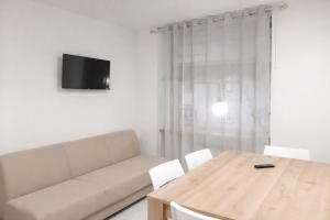 a living room with a couch and a wooden table at MontBliss in Saint Vincent