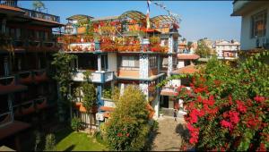 a building with flowers on the side of it at Boudha Orange Hotel in Kathmandu