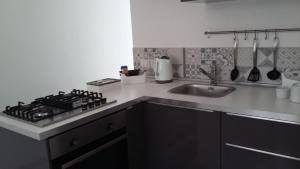 a kitchen with a stove and a sink at Casa Umberto I in Catania